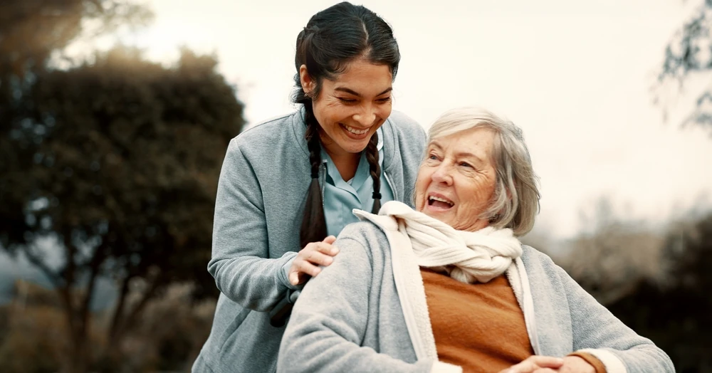 Caregiver with an older woman outdoors