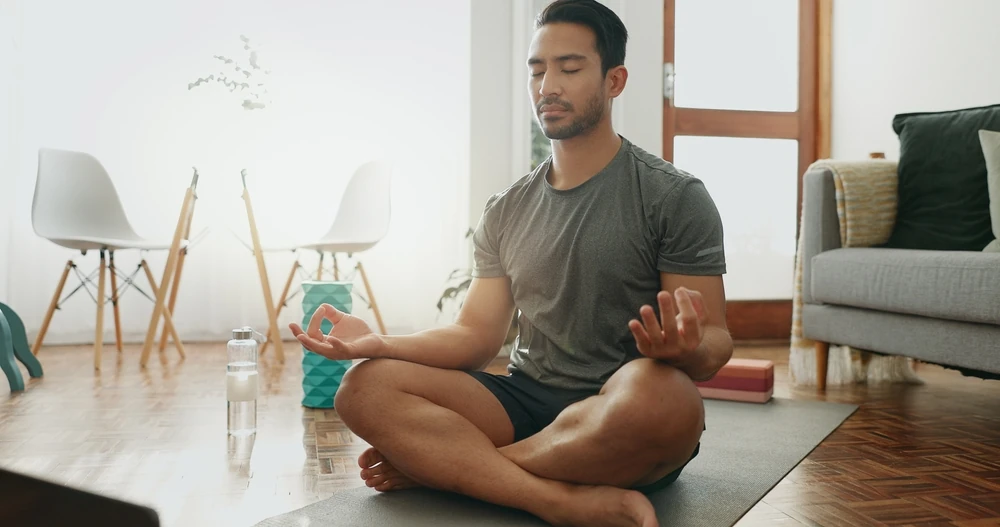 Man meditating at home
